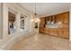Dining area featuring a window view, a chandelier, and ample wooden cabinet space at 8540 E Mcdowell Rd # 119, Mesa, AZ 85207