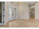 An entryway featuring tile floors, a decorative chandelier, and a glass paneled double door at 8540 E Mcdowell Rd # 119, Mesa, AZ 85207