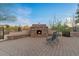A stone fireplace with seating offers a cozy and inviting outdoor gathering spot at 8540 E Mcdowell Rd # 119, Mesa, AZ 85207