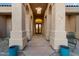 Elegant entryway with decorative pillars, a hanging light fixture, and glass front doors at 8540 E Mcdowell Rd # 119, Mesa, AZ 85207