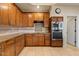 Well-equipped kitchen with wooden cabinets, granite countertops, and modern stainless steel appliances at 8540 E Mcdowell Rd # 119, Mesa, AZ 85207