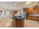 Kitchen featuring wooden cabinets, stainless steel appliances, and a functional center island at 8540 E Mcdowell Rd # 119, Mesa, AZ 85207