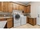 Convenient laundry room with modern washer, dryer, ample cabinets, and granite countertops at 8540 E Mcdowell Rd # 119, Mesa, AZ 85207