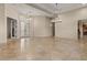 Light filled living room open to the entryway and featuring tile floors and recessed lights at 8540 E Mcdowell Rd # 119, Mesa, AZ 85207