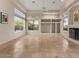 Living room featuring many windows, neutral paint, built-in shelving, and a fireplace at 8540 E Mcdowell Rd # 119, Mesa, AZ 85207