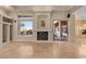 Open living room with fireplace, tile floors, and bright windows showcasing the beautiful outdoor living space at 8540 E Mcdowell Rd # 119, Mesa, AZ 85207