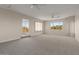Bright living room features neutral carpet, ceiling fans and large windows overlooking desert landscaping at 8540 E Mcdowell Rd # 119, Mesa, AZ 85207