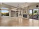 Bright living room with high ceilings, large windows, a fireplace, and built-in shelving at 8540 E Mcdowell Rd # 119, Mesa, AZ 85207