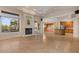 Living room featuring a fireplace, access to the patio, and the kitchen in an open floor plan at 8540 E Mcdowell Rd # 119, Mesa, AZ 85207