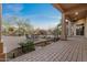 A covered brick patio with an outdoor fireplace offers a blend of comfort and outdoor living at 8540 E Mcdowell Rd # 119, Mesa, AZ 85207