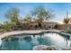 Desert backyard with pool and raised spa, covered patio, and wrought iron fence at 8540 E Mcdowell Rd # 119, Mesa, AZ 85207