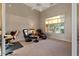 Sitting room with two leather arm chairs and a view of the natural landscape through a large window at 8540 E Mcdowell Rd # 119, Mesa, AZ 85207