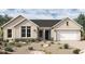 Charming single-story home featuring stone accents and a two-car garage in a well-manicured desert landscape at 953 W Ridge Rd, Apache Junction, AZ 85120