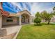 Expansive backyard featuring lush green grass, covered patio, and architectural details at 10130 E San Salvador Dr, Scottsdale, AZ 85258