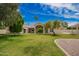 Large backyard with mature trees, a lush lawn, and a charming architectural style at 10130 E San Salvador Dr, Scottsdale, AZ 85258