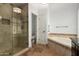 Bathroom featuring a glass shower, soaking tub, and tile accents at 10130 E San Salvador Dr, Scottsdale, AZ 85258
