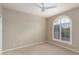 Neutral bedroom with neutral paint, carpet, and an arched window with decorative shutters at 10130 E San Salvador Dr, Scottsdale, AZ 85258