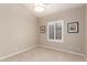 Neutral bedroom with natural light, modern light fixture, neutral paint, and wall decor at 10130 E San Salvador Dr, Scottsdale, AZ 85258