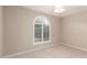Neutral bedroom features neutral paint, carpet, arched window with shutters, and modern light fixture at 10130 E San Salvador Dr, Scottsdale, AZ 85258