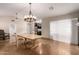 Spacious dining area with tile floors, a modern chandelier, and backyard views at 10130 E San Salvador Dr, Scottsdale, AZ 85258