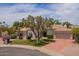 Charming single-story home featuring a well-manicured front yard and a two car garage at 10130 E San Salvador Dr, Scottsdale, AZ 85258