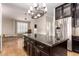 Bright kitchen featuring a large island, stainless steel appliances, and stylish chandelier at 10130 E San Salvador Dr, Scottsdale, AZ 85258