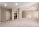 Open living area with neutral carpet, archway accents, and sliding door to the backyard at 10130 E San Salvador Dr, Scottsdale, AZ 85258