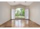 Bright, expansive living room featuring a large window with backyard views and tile flooring at 10130 E San Salvador Dr, Scottsdale, AZ 85258