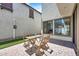 A backyard featuring a cozy brick patio with dining set and string lights at 10428 E Nopal Ave, Mesa, AZ 85209