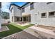 Large backyard with brick patio, artificial grass, and modern stucco exterior at 10428 E Nopal Ave, Mesa, AZ 85209
