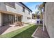 Charming backyard features a brick patio, artificial grass, and tasteful landscaping at 10428 E Nopal Ave, Mesa, AZ 85209