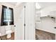 A peek into a bathroom and walk-in closet with ample shelving, storage, and modern finishes at 10428 E Nopal Ave, Mesa, AZ 85209