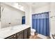 Bathroom featuring a vanity with dark cabinets, a large mirror, and a shower with a curtain at 10428 E Nopal Ave, Mesa, AZ 85209