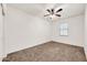 Bedroom featuring neutral walls and carpet, a ceiling fan, and a window at 10428 E Nopal Ave, Mesa, AZ 85209