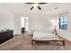 Light-filled bedroom with neutral carpet, a modern platform bed, and an en suite bathroom at 10428 E Nopal Ave, Mesa, AZ 85209