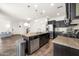 Well-lit kitchen featuring stainless steel appliances, granite counters, central island and wood-look floors at 10428 E Nopal Ave, Mesa, AZ 85209
