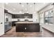 Bright kitchen with stainless appliances, spacious island with granite counters, and ample cabinet space at 10428 E Nopal Ave, Mesa, AZ 85209