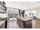 Modern kitchen with granite counters, stainless appliances and island that opens to the living room at 10428 E Nopal Ave, Mesa, AZ 85209