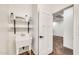 Laundry room featuring a utility sink, shelving, and a door leading to another room at 10428 E Nopal Ave, Mesa, AZ 85209