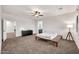 Spacious main bedroom with a ceiling fan, neutral carpet, and access to a bathroom at 10428 E Nopal Ave, Mesa, AZ 85209