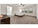 Main bedroom with three windows allowing for great natural light and neutral carpet at 10428 E Nopal Ave, Mesa, AZ 85209