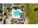Stunning aerial view of community pool area with lounge chairs, shade pavilions, and verdant landscaping at 10428 E Nopal Ave, Mesa, AZ 85209