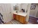Bathroom with a vanity, mirror, and a decorative mat on the tiled floor at 10441 W Windsor Ave, Avondale, AZ 85392