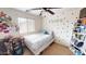 Cozy bedroom with ceiling fan, polka-dot wall decorations and a brightly decorated student area at 10441 W Windsor Ave, Avondale, AZ 85392