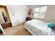 Bright bedroom with a large window, closet, study area, and comfortable sleeping space at 10441 W Windsor Ave, Avondale, AZ 85392