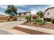 Well-maintained two-story home with a three-car garage, desert landscaping, and mature trees at 10441 W Windsor Ave, Avondale, AZ 85392