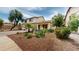 Charming two-story home featuring lush desert landscaping and a welcoming front porch at 10441 W Windsor Ave, Avondale, AZ 85392