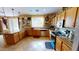 Well-equipped kitchen featuring granite countertops, tile flooring, and plenty of cabinets at 10441 W Windsor Ave, Avondale, AZ 85392