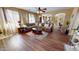 Bright living room with large windows, a plush sofa, and an open layout at 10441 W Windsor Ave, Avondale, AZ 85392