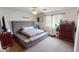 Comfortable bedroom with a modern bed, dresser, and large window for natural light at 10441 W Windsor Ave, Avondale, AZ 85392